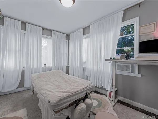 a room with a bed and a flat screen tv