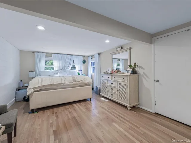 a spacious bedroom with a bed and a cabinets