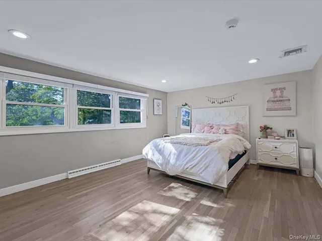 a bedroom with a bed and windows