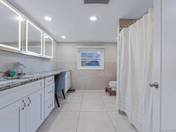 a hallway with cabinets and window