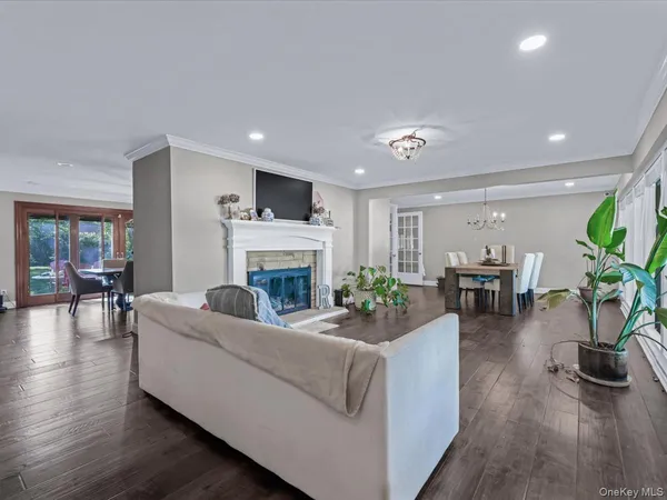 a living room with furniture a fireplace and a potted plant