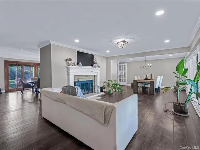 a living room with furniture a fireplace and a potted plant