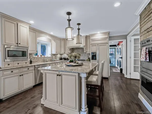 a kitchen with stainless steel appliances granite countertop a stove and cabinets