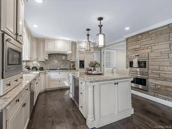 a kitchen with white cabinets and appliances