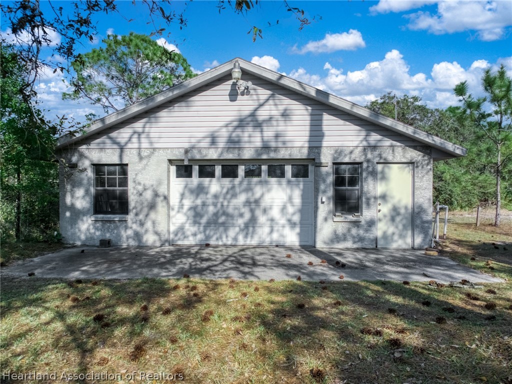 5802 Golden Road Sebring, FL 33875 - Photo 31 of 37 a front view of a house with a yard