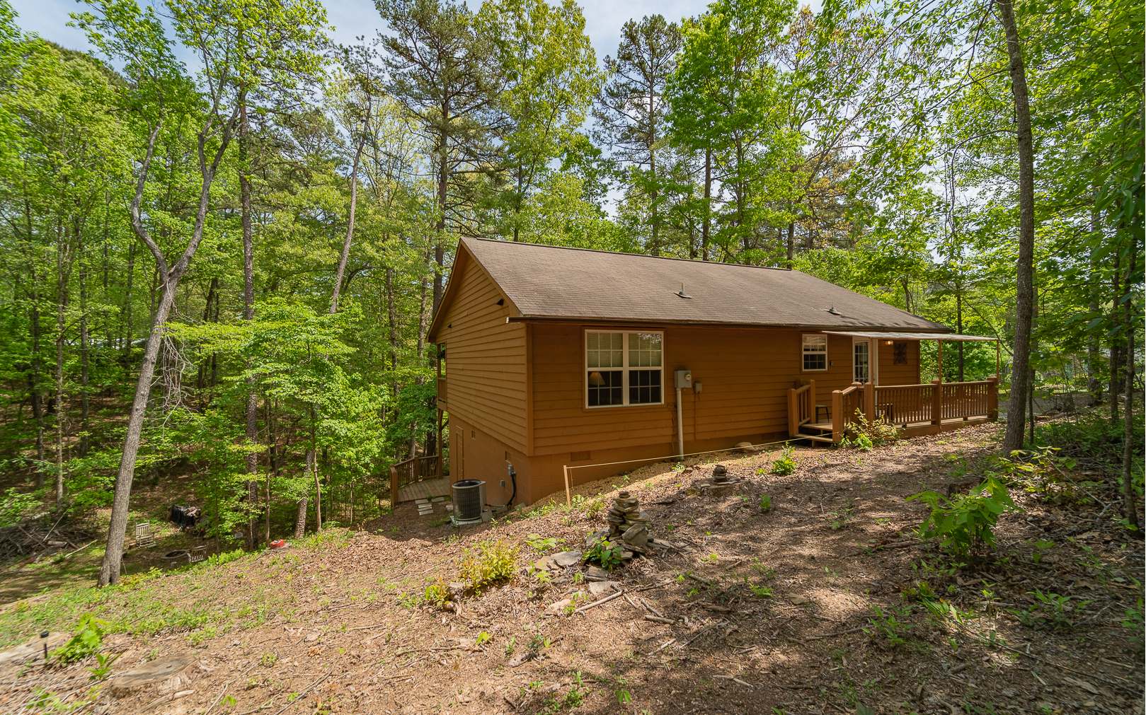 64 Driver Avenue Murphy, NC 28906 - Photo 3 of 4 a backyard of a house with large trees and brick walls