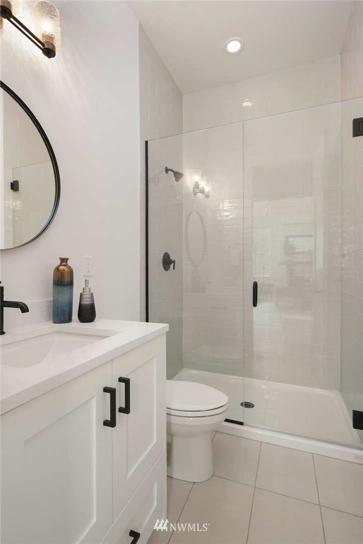 23521 7th Avenue Southeast Bothell, WA 98021 - Photo 15 of 27 a bathroom with a granite countertop sink toilet a mirror and shower