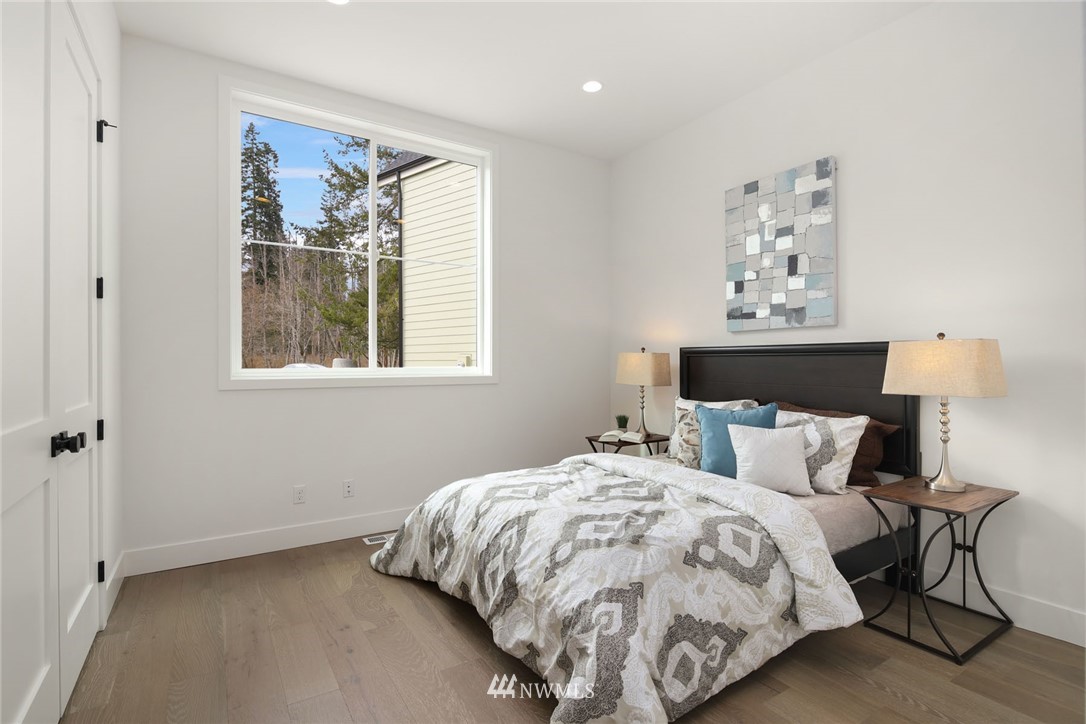 23521 7th Avenue Southeast Bothell, WA 98021 - Photo 16 of 27 a bedroom with a bed and painting on the wall