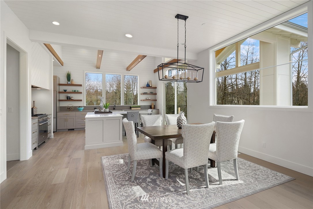 23521 7th Avenue Southeast Bothell, WA 98021 - Photo 3 of 27 a view of a dining room with furniture window and wooden floor