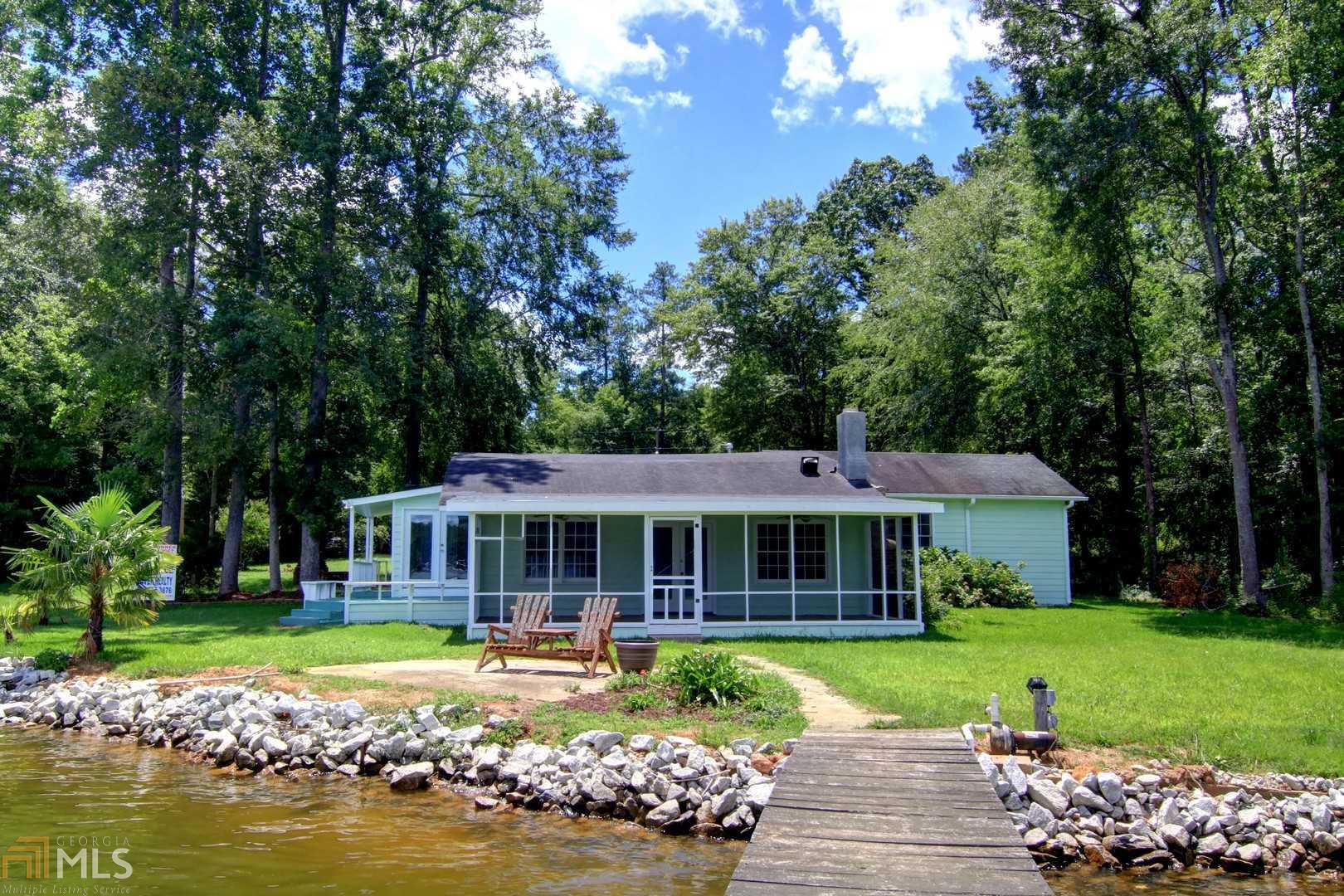 134 Sunset Cove Road Jackson, GA 30233 - Photo 1 of 1 a front view of a house with swimming pool having outdoor seating