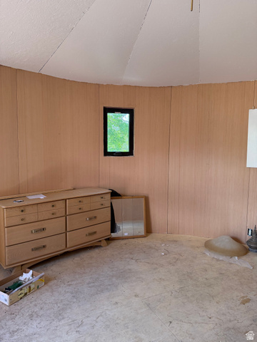 255 E Centre Spring City, UT 84662 - Photo 31 of 34 Curved interior wall paneling with a single window, textured ceiling, and unfinished flooring