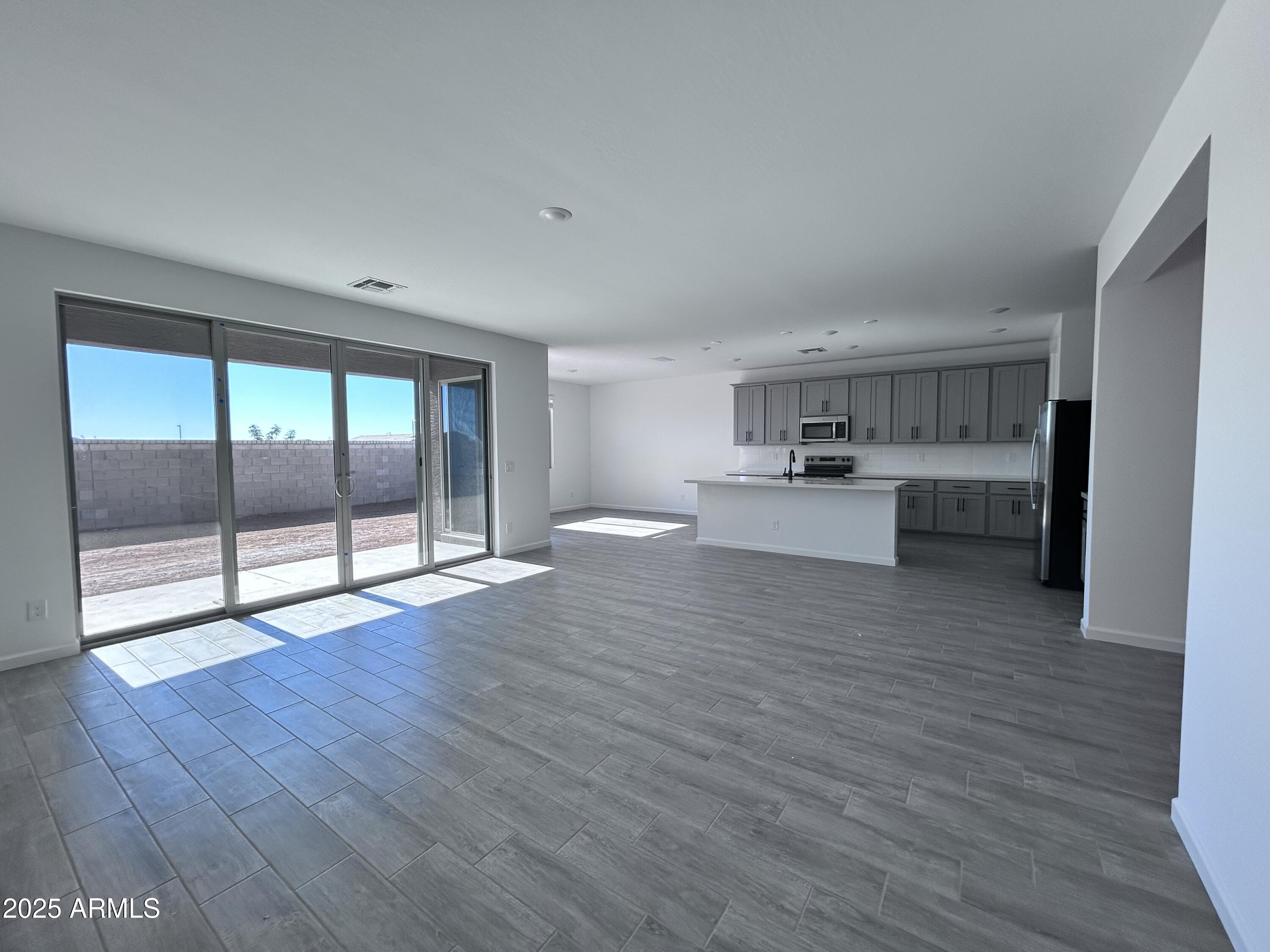 2603 Rustler Road San Tan Valley, AZ 85140 - Photo 11 of 34 a view of a kitchen with wooden floor and a window