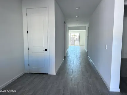 a view of a hallway with wooden floor
