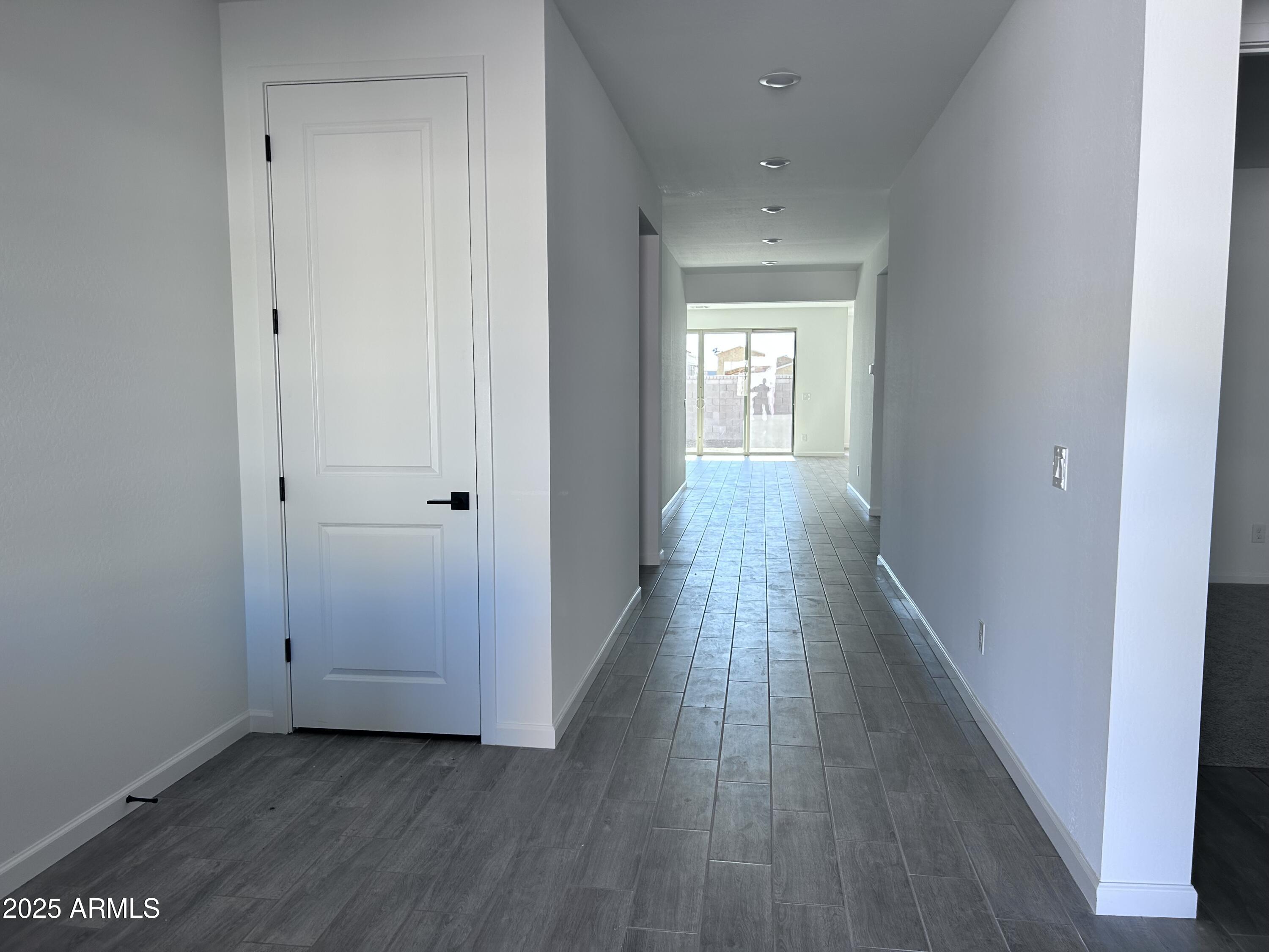 2603 Rustler Road San Tan Valley, AZ 85140 - Photo 3 of 34 a view of a hallway with wooden floor