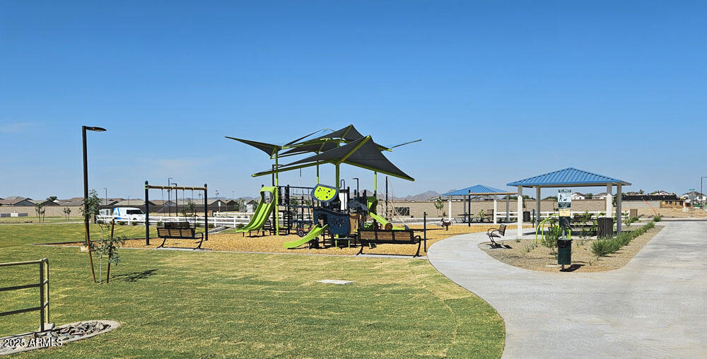 2603 Rustler Road San Tan Valley, AZ 85140 - Photo 33 of 34 a view of a swimming pool with a table and chairs