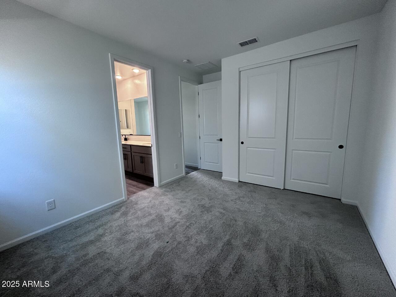 2603 Rustler Road San Tan Valley, AZ 85140 - Photo 5 of 34 a view of an empty room with a closet