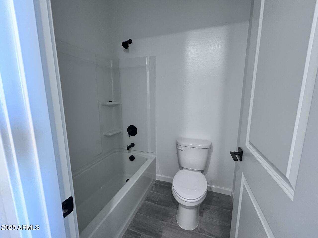 2603 Rustler Road San Tan Valley, AZ 85140 - Photo 7 of 34 a bathroom with a toilet and a shower