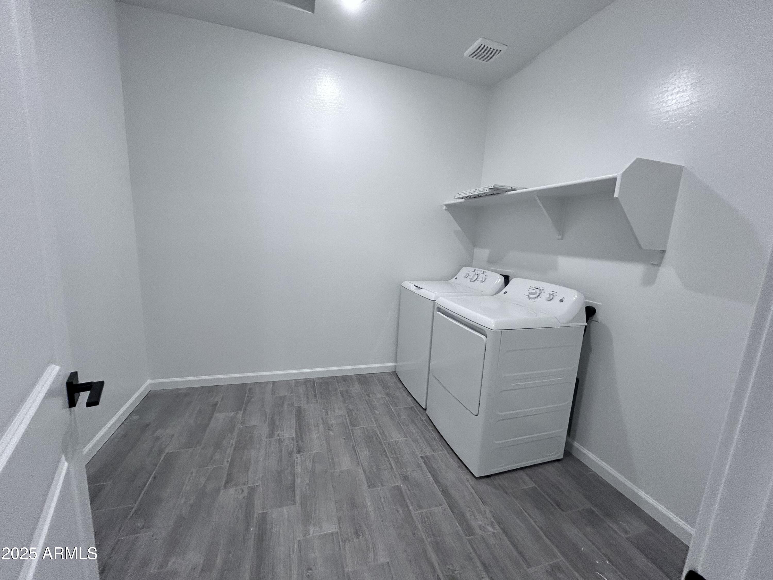 2603 Rustler Road San Tan Valley, AZ 85140 - Photo 10 of 34 a utility room with wooden floor washer and dryer