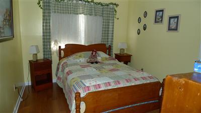 35 South Sunken Meadow Road Eastham, MA 02642 - Photo 11 of 22 a bedroom with a bed and wooden floor