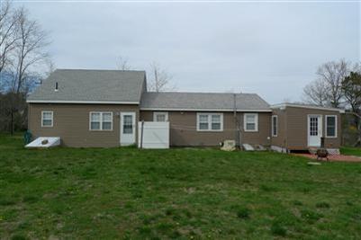 35 South Sunken Meadow Road Eastham, MA 02642 - Photo 18 of 22 a front view of a house with a yard