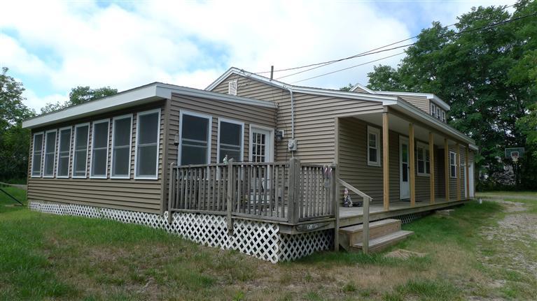 35 South Sunken Meadow Road Eastham, MA 02642 - Photo 2 of 22 a front view of a house with a garden