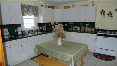 35 South Sunken Meadow Road Eastham, MA 02642 - Photo 4 of 22 a kitchen with a sink a stove and white cabinets