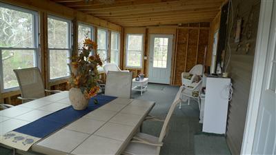 35 South Sunken Meadow Road Eastham, MA 02642 - Photo 10 of 22 a living room with furniture and floor to ceiling windows