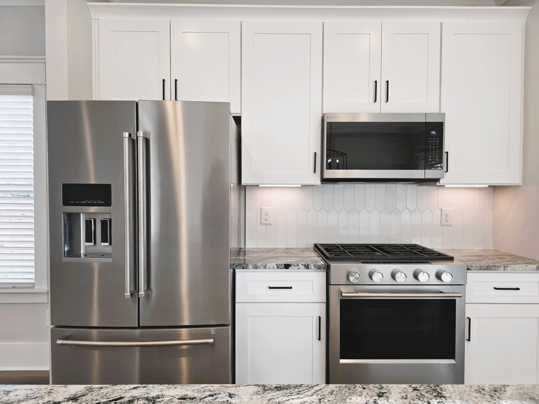 369 Springbrook Boulevard White House, TN 37188 - Photo 10 of 30 a kitchen with stainless steel appliances a stove a microwave and a refrigerator