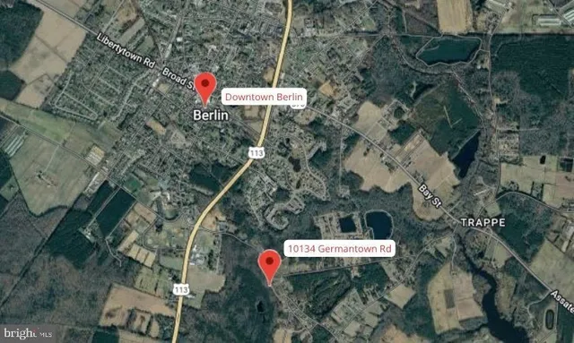 an aerial view of a house with a yard and outdoor seating