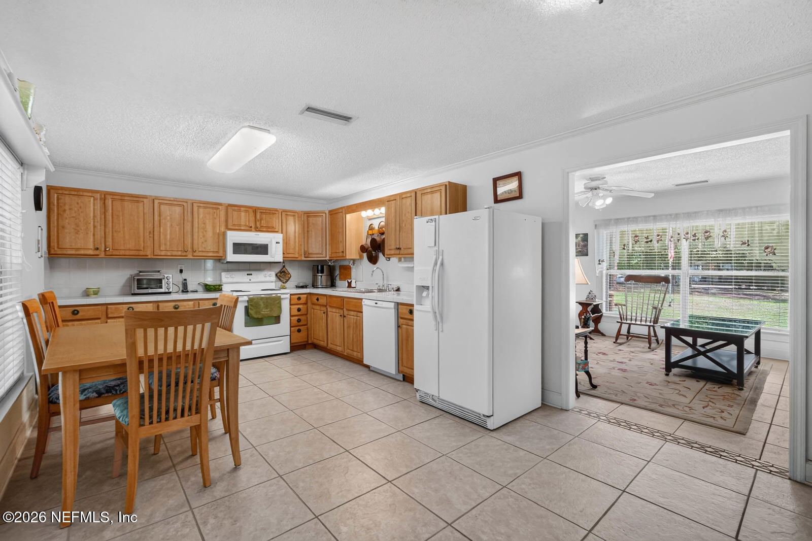 1950 Lightsey Road St. Augustine, FL 32084 - Photo 14 of 57 a kitchen with a refrigerator a counter top space and appliances