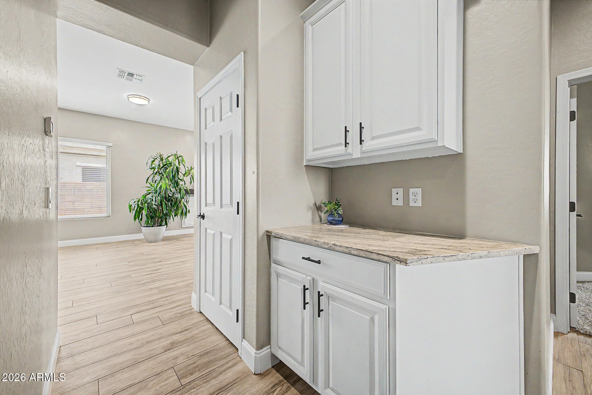 4272 East Buckboard Road Gilbert, AZ 85297 - Photo 18 of 37 a kitchen with granite countertop a white stove top oven and white cabinets