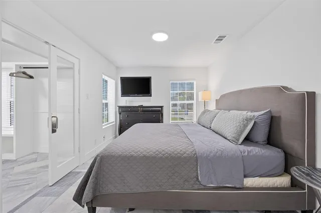 a bedroom with a bed and a flat screen tv