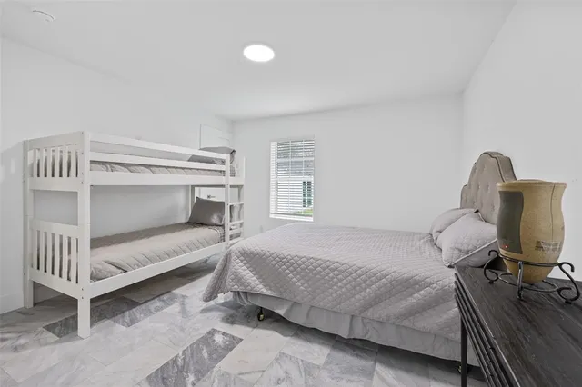 a bedroom with a bed and a desk