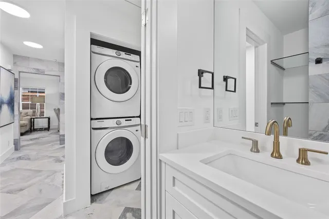a bathroom with a sink a washer and dryer
