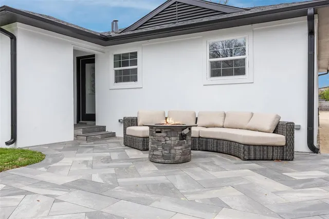a view of a patio with couches and a potted plant