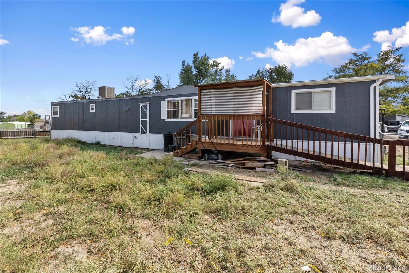 600 Raintree Boulevard, Unit 98 Canon City, CO 81212 - Photo 1 of 25 a backyard of a house with table and sofas