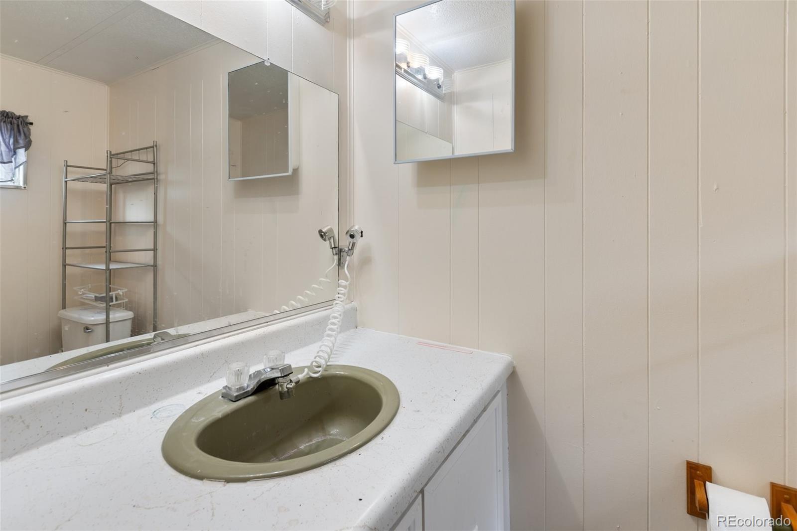 600 Raintree Boulevard, Unit 98 Canon City, CO 81212 - Photo 13 of 25 a bathroom with a sink and a mirror