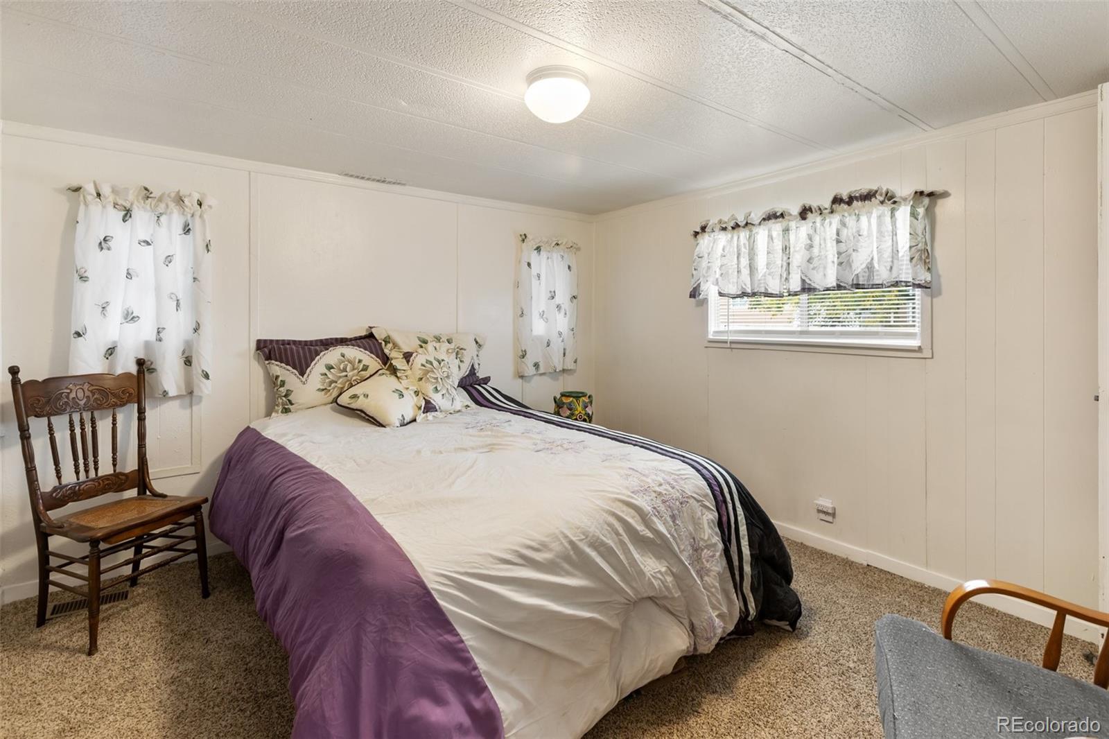 600 Raintree Boulevard, Unit 98 Canon City, CO 81212 - Photo 14 of 25 a bedroom with a bed and a chair