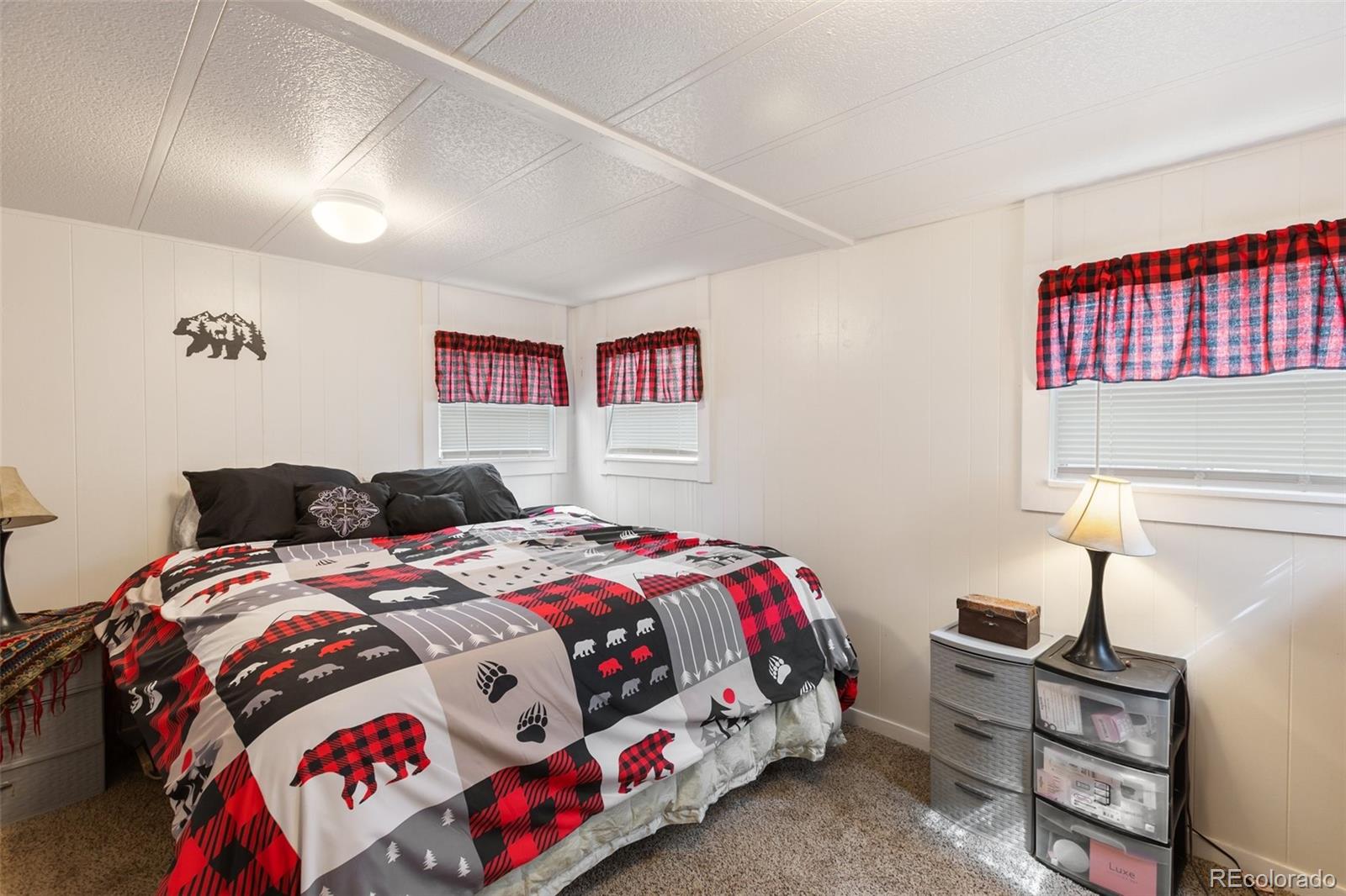 600 Raintree Boulevard, Unit 98 Canon City, CO 81212 - Photo 16 of 25 a bedroom with a bed and a chandelier