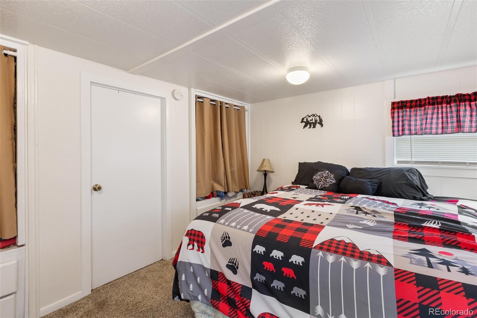600 Raintree Boulevard, Unit 98 Canon City, CO 81212 - Photo 18 of 25 a bedroom that has a bed and a dresser in it