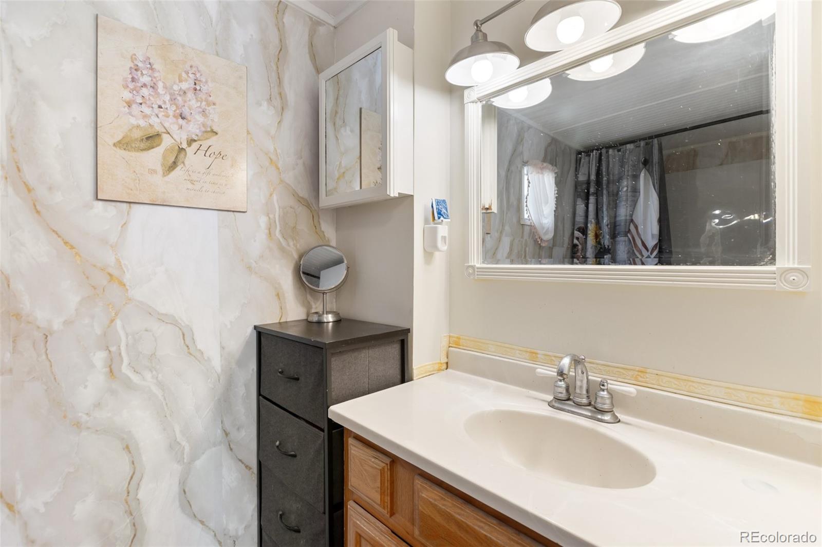 600 Raintree Boulevard, Unit 98 Canon City, CO 81212 - Photo 20 of 25 a bathroom with a sink vanity and a mirror