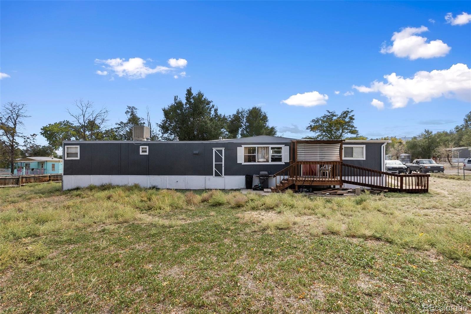 600 Raintree Boulevard, Unit 98 Canon City, CO 81212 - Photo 2 of 25 a view of a house with a yard