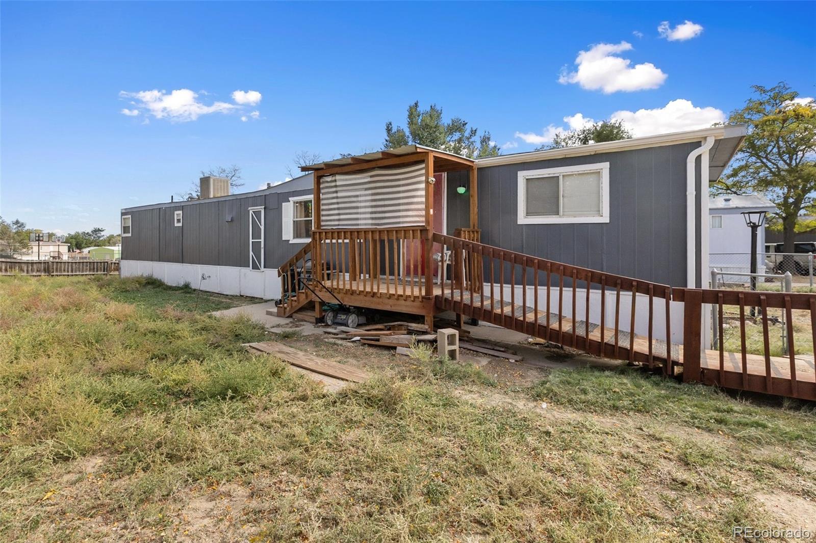600 Raintree Boulevard, Unit 98 Canon City, CO 81212 - Photo 22 of 25 a view of a house with a yard and deck
