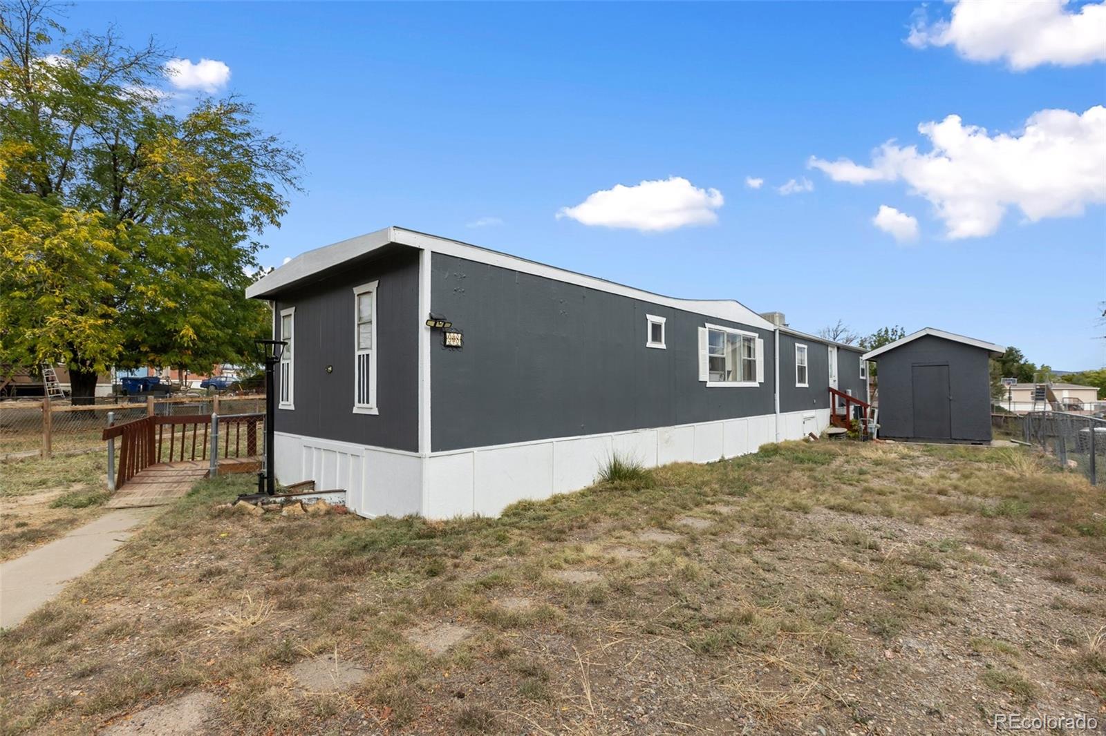 600 Raintree Boulevard, Unit 98 Canon City, CO 81212 - Photo 4 of 25 a front view of a house with a yard