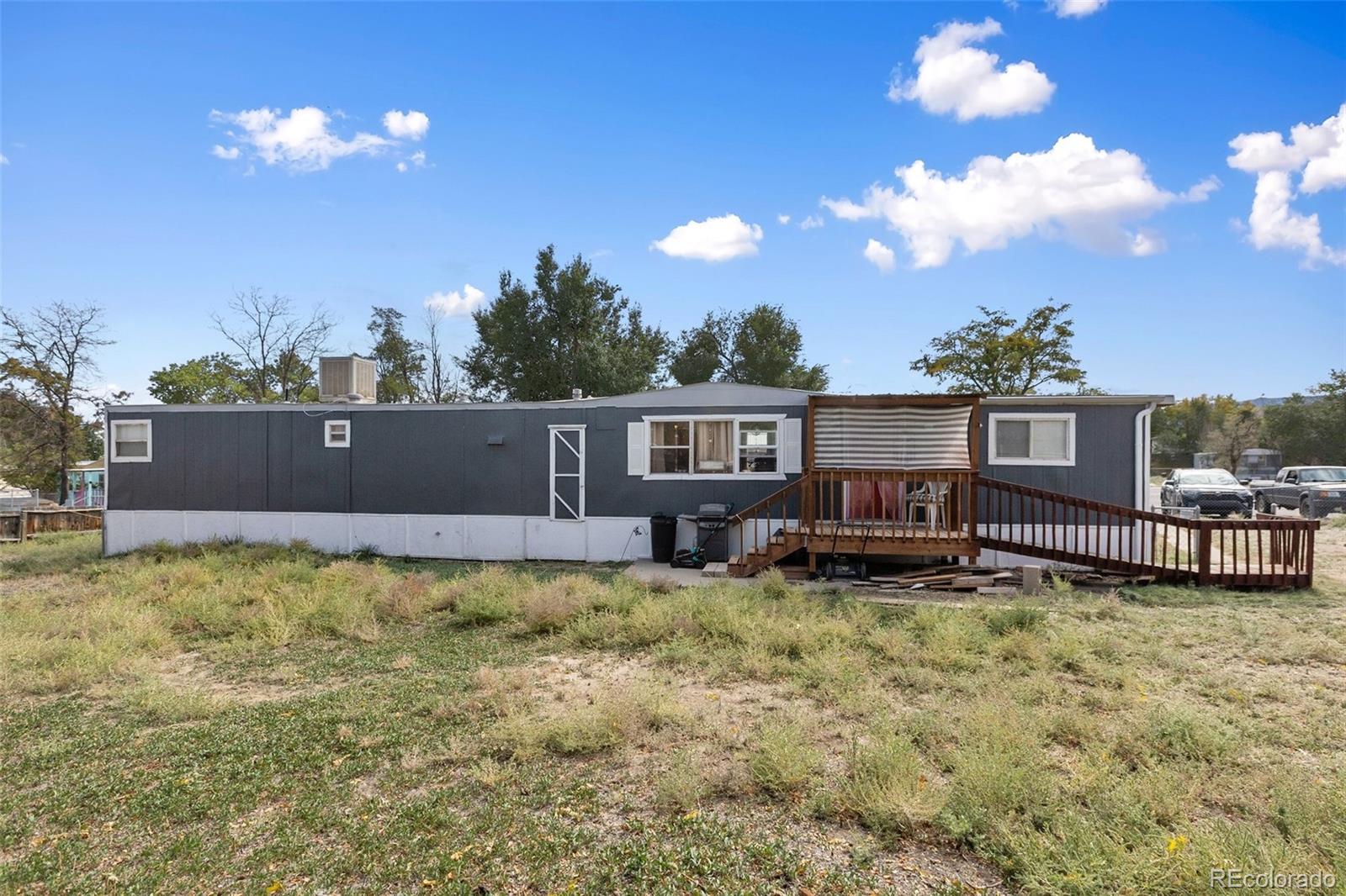 600 Raintree Boulevard, Unit 98 Canon City, CO 81212 - Photo 6 of 25 a view of a house with swimming pool and a yard