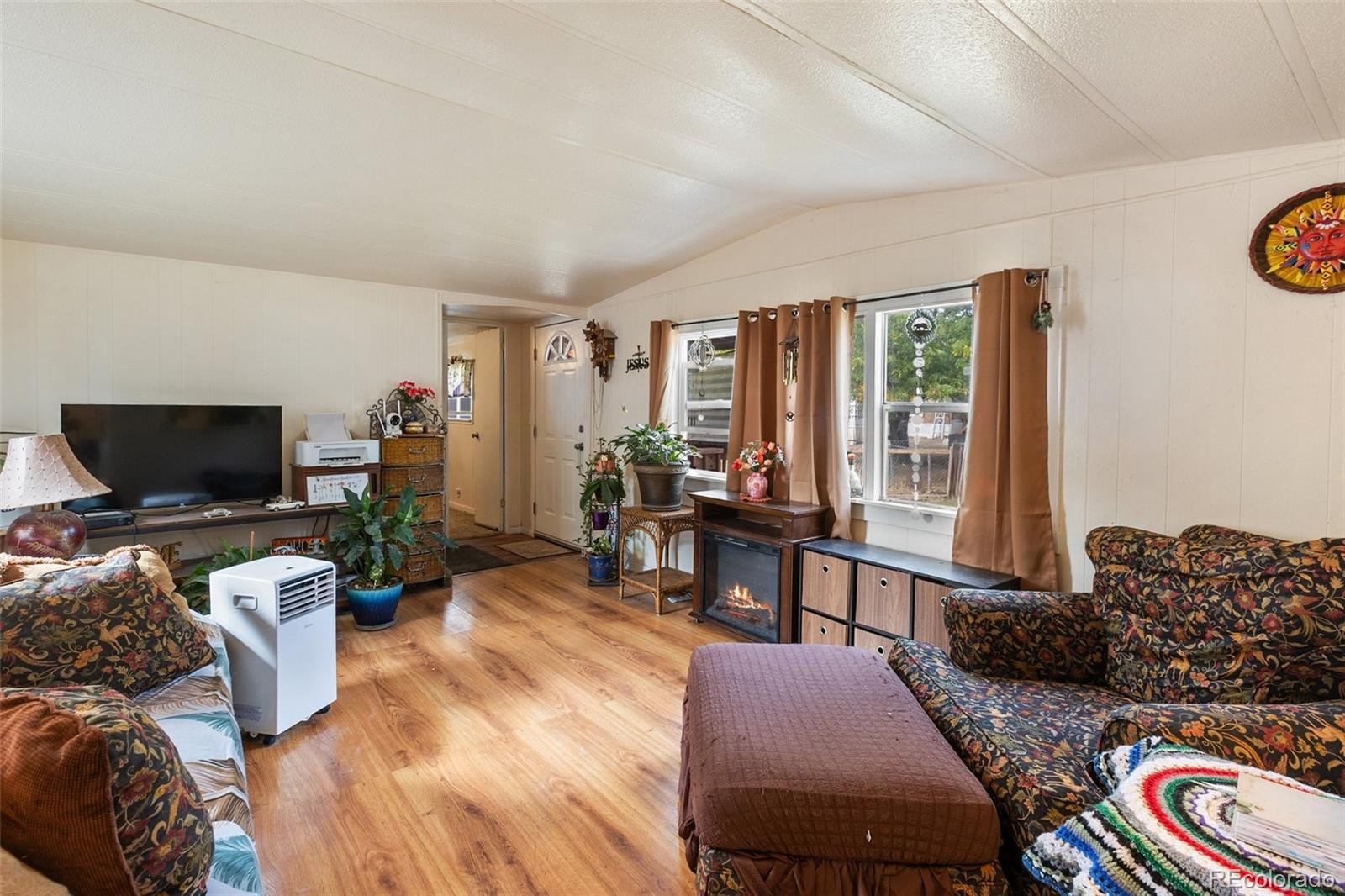 600 Raintree Boulevard, Unit 98 Canon City, CO 81212 - Photo 8 of 25 a living room with furniture and a flat screen tv