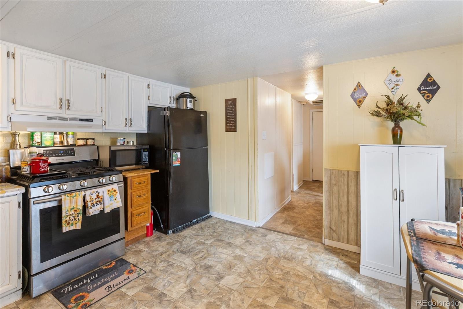 600 Raintree Boulevard, Unit 98 Canon City, CO 81212 - Photo 10 of 25 a kitchen with stainless steel appliances granite countertop a refrigerator a stove and a sink