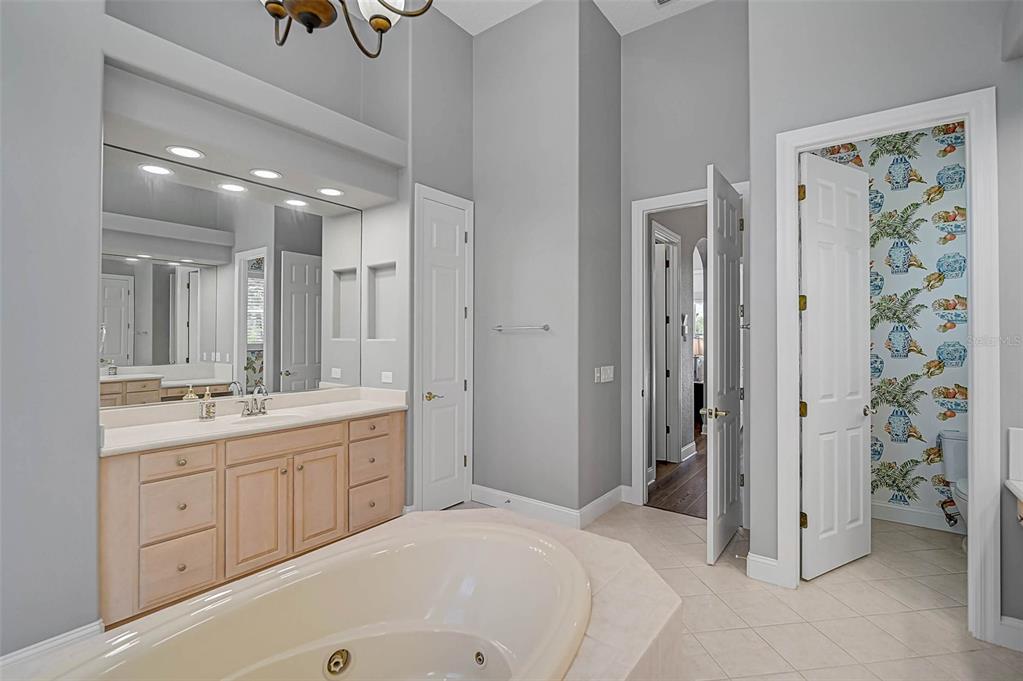 538 Dove Pointe Osprey, FL 34229 - Photo 28 of 74 a spacious bathroom with a double vanity sink a large mirror a shower and a bathtub