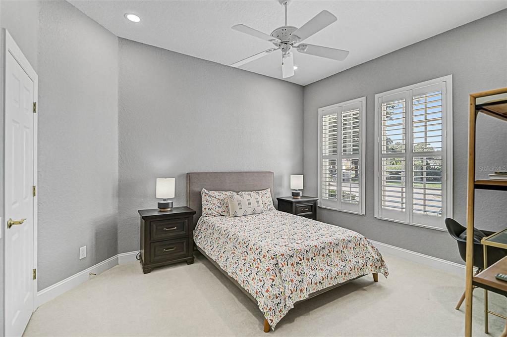 538 Dove Pointe Osprey, FL 34229 - Photo 34 of 74 a bedroom with a bed a chandelier and a window