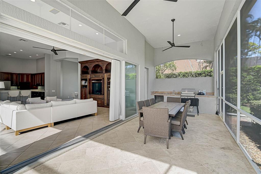 538 Dove Pointe Osprey, FL 34229 - Photo 39 of 74 a living room with furniture a flat screen tv and a large window